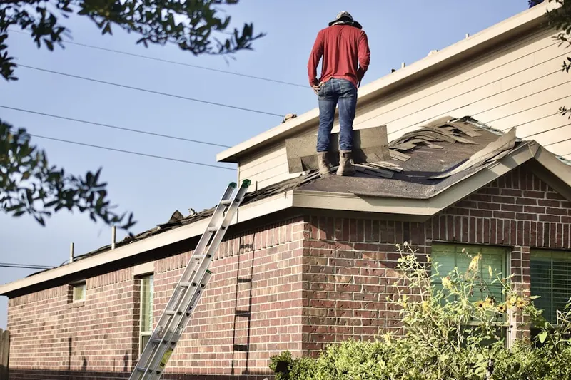 Professional roofer working on a residential roof in Elgin